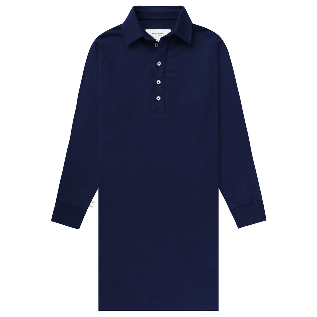 Woman standing in field wearing long sleeve navy polo dress